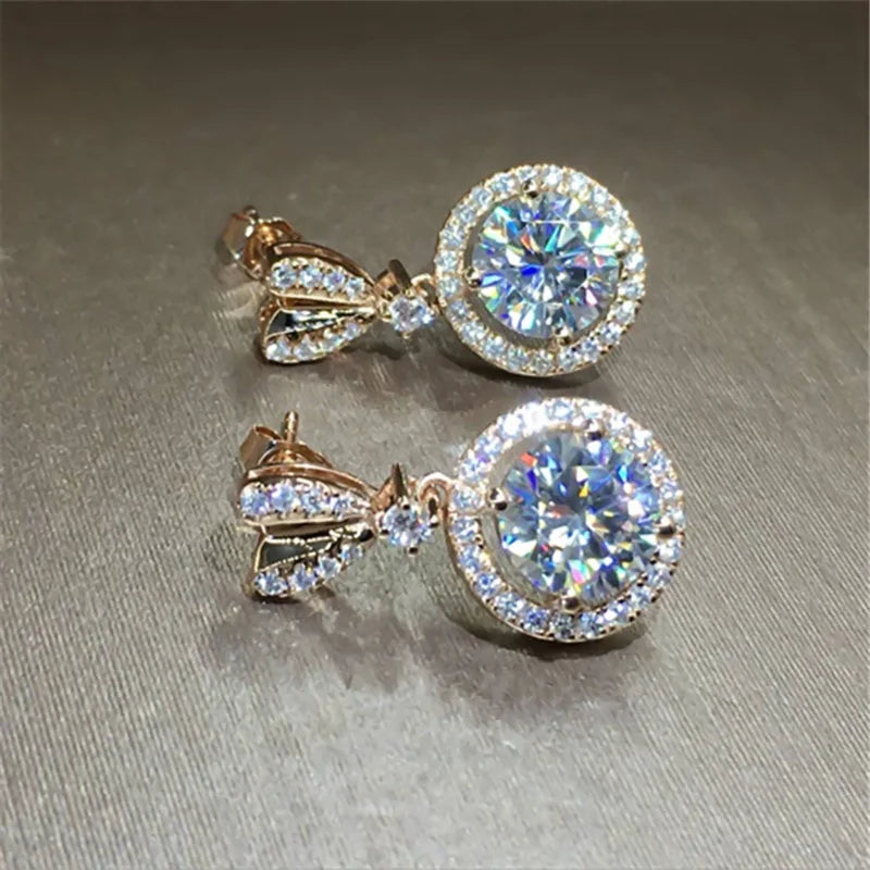1. gioielli - orecchini pendenti color oro rosa con zirconi
